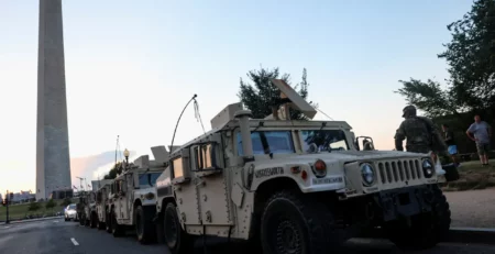 Original Photo from the Guardian US of Armoured Vehicles parked under George Washington’s Memorial. August 17, 2025